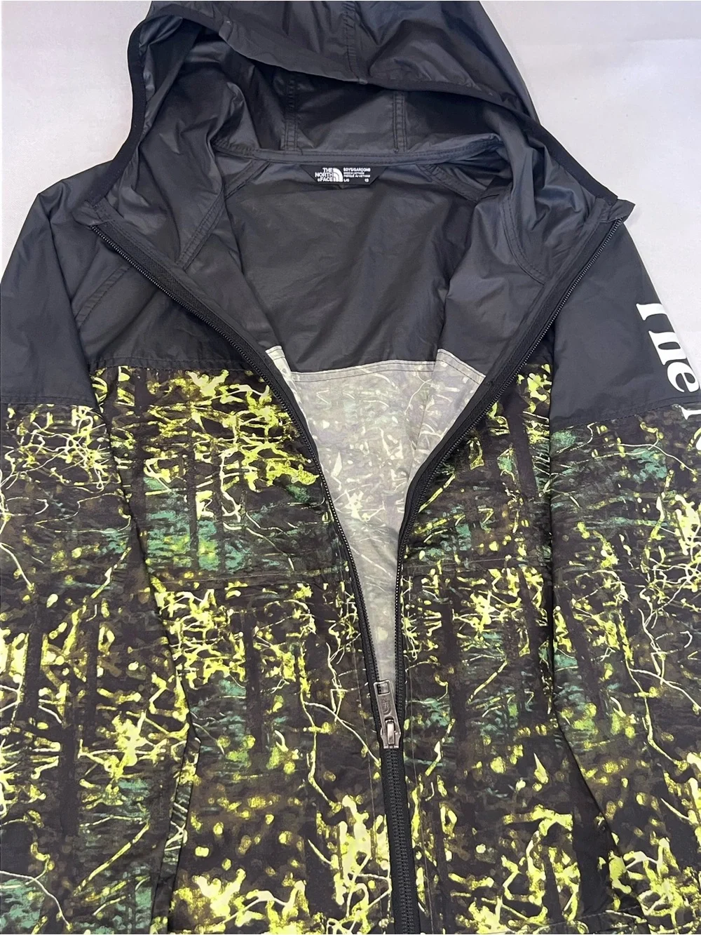 The North Face Kids Black Hooded Rain Jacket with Neon Green Print
